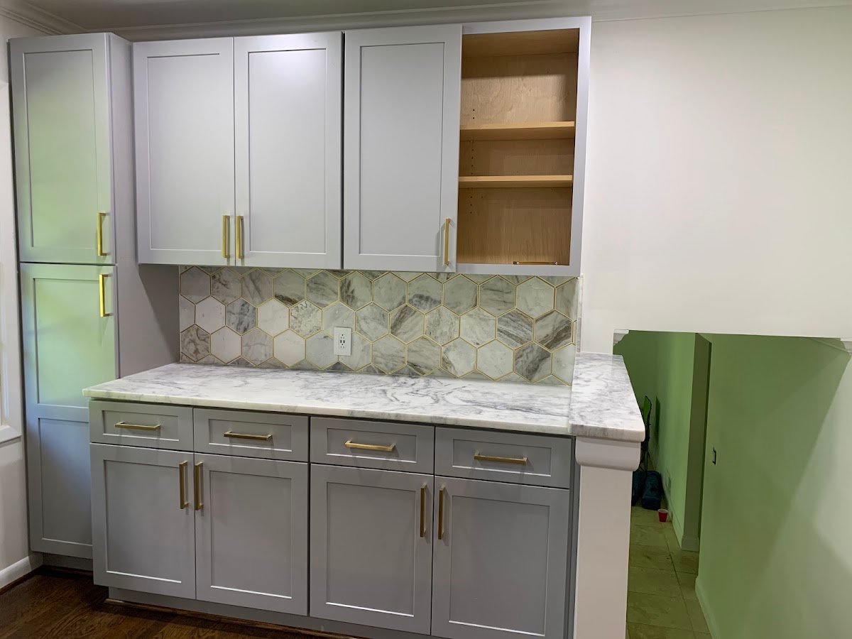 Kitchen remodel with gray shaker cabinets and marble hexagon backsplash